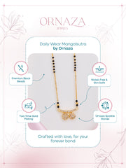 Gold necklace with black beads on a display card, featuring Ornaza Jewels branding.