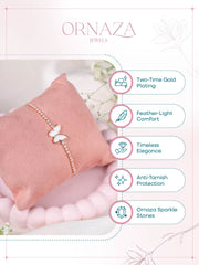 Butterfly bracelet on a pink pillow with Ornaza Jewels branding and feature text.