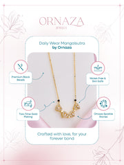 Gold necklace with black beads on a white background, featuring Ornaza Jewels branding.